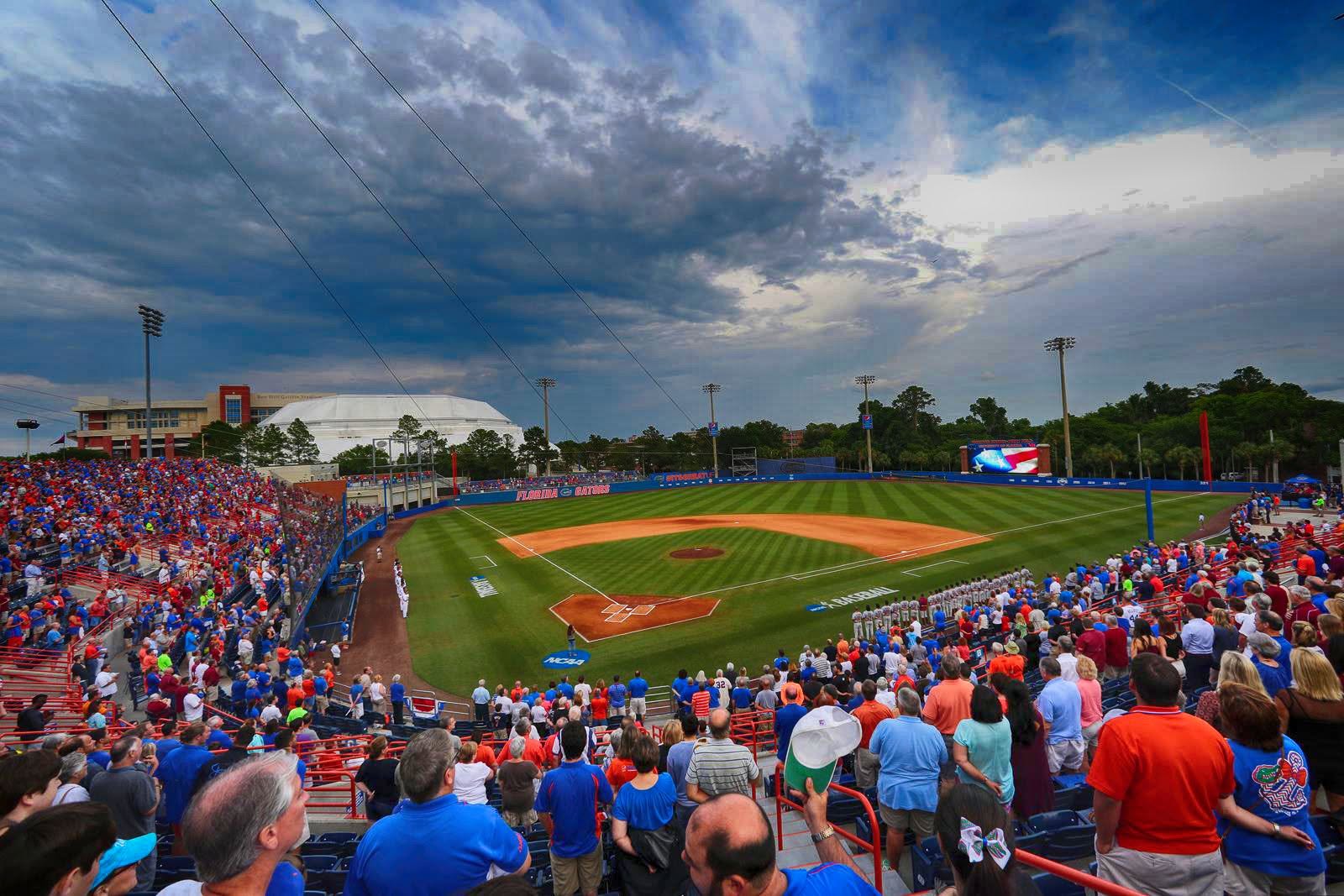 Baseball stadium crowd and field under storm clouds